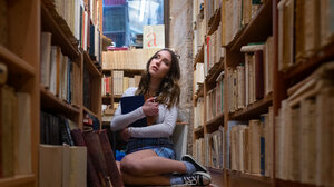 Women Books Library Bookshelves Women With Glasses Plaid Skirt Legs Together Hugging Self 6144x4096 Wallpaper